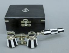 A boxed pair of opera glasses. The box 13 cm wide.