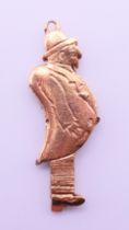 A 9ct gold charm/pendant formed as a flashing man. 3 cm high. 2.4 grammes total weight.