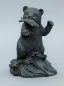 A bronze bear with fish in mouth. 17 cm high.