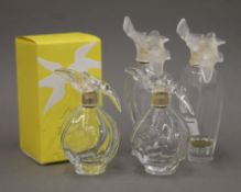 Four Nina Ricci perfume bottles, one boxed. The largest 17 cm high.