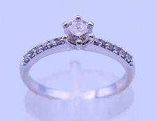An 18 ct white gold and 0.35 carat diamond ring. Ring size L/M. 2.5 grammes total weight.