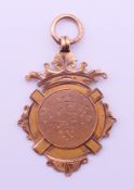 A 9 ct gold medal fob inscribed Ely City FC, the reverse inscribed CFA Senior Cup, 1910-11,