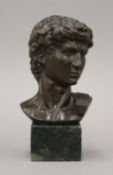 A bronze bust of a man on a marble stand. 17 cm high.