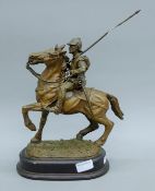 A cast resin and metal model of a cavalry man on horseback. 37 cm high overall.