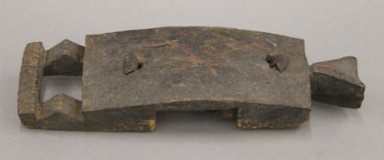 An African tribal carved wooden door handle of figural form. 29 cm high.