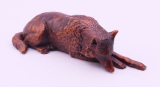 A wooden model of a wolf. 10.5 cm long.