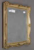 A small gilt-framed bevelled mirror. 31 x 38 cm.