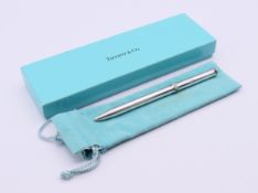 A boxed Tiffany & Co silver ballpoint pen (clip lacking). 12.5 cm long.