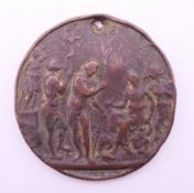 An antique bronze medallion. 5 cm diameter.
