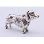 An 800 silver vesta formed as a dachshund. 7 cm long.