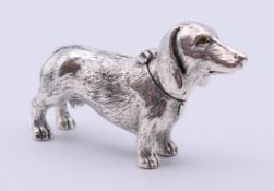 An 800 silver vesta formed as a dachshund. 7 cm long.