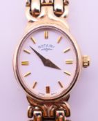 A 9 ct gold Rotary ladies' wristwatch on a 9 ct gold bracelet strap, boxed. 1.7 cm including crown.