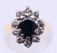 An 18 ct gold, diamond and sapphire ring. Ring size I/J. 5.7 grammes total weight.