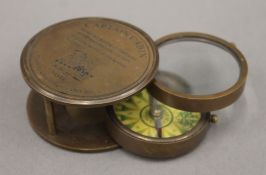 A boxed compass and magnifying glass. The box 9 cm wide.