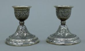 A pair of Indian silver candlesticks. Each 8 cm high. 219 grammes.