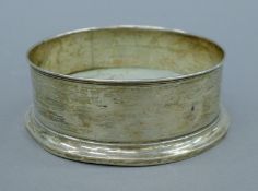 A silver bottle coaster. 12.5 cm diameter. 83 grammes of silver.