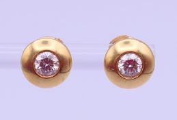 A pair of 18 ct gold and diamond ear studs, each stone approximately 0.25 ct. Each 8 mm diameter. 3.