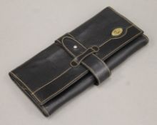 A Gucci leather jewellery wallet. 22 cm wide.
