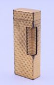 A Dunhill gold-plated lighter. 6.4 cm high.