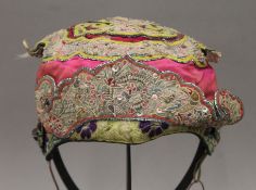 A 19th century Chinese embroidered child's hat. 20 cm wide.
