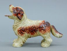 A cast iron dog money bank. 19 cm long.