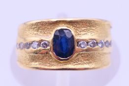 An unmarked gold, diamond and sapphire ring. Ring size F. 3.8 grammes total weight.