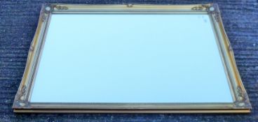 A modern gilt-framed mirror. 106 x 137 cm.
