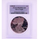 A silver proof Liberty dollar 1999-P-slabbed.
