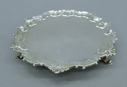 A George II silver salver of circular form with shell and scroll border,