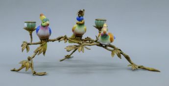 A porcelain and gilt metal bird form candelabra. 53 cm wide.