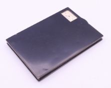 An unmarked silver and enamel cigarette case with integrated watch. 11 cm wide.