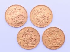 Four gold sovereigns (1890, 1903, 1906, 1912).