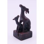 A bronze double deer seal. 5 cm high.