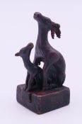 A bronze double deer seal. 5 cm high.
