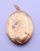A 9 ct gold locket, the reverse inscribed Confirmation 5-2-78. 11.2 grammes. 4 cm high.