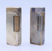 Two Dunhill plated cigarette lighters. Each 6.5 cm high.
