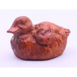 A carved wooden duck. 5.5 cm long.