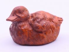 A carved wooden duck. 5.5 cm long.