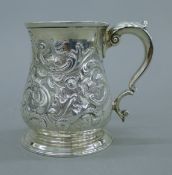 A George II silver tankard with leaf cast C scroll handle,