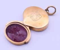 An unmarked gold and carnelian swivel seal fob pendant inscribed Laura Thornton 1833 to one side