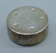 A silver paperweight. 5.25 cm diameter.