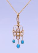 A 15 ct gold, turquoise and pearl pendant on a 9 ct gold chain. Pendant 3.