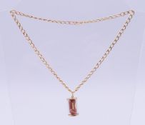 A 9 ct gold chain and a 9 ct gold-mounted 10 shilling note charm. Charm 2.