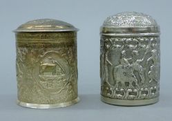 Two Indian silver embossed lidded boxes. The larger 10.5 cm high. 365.1 grammes.