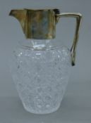 A silver-mounted cut glass claret jug. 19 cm high.