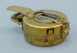 A brass compass. 6 cm diameter.