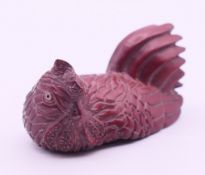 A carved wooden chicken netsuke. 5.5 cm long.