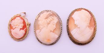 Three cameo brooches, one set on 9 ct gold. 9 ct gold cameo 3 cm high, others 4 cm and 3.5 cm high.