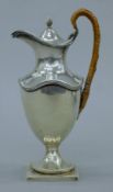 A silver water jug. 17 cm high. 196.4 grammes total weight.
