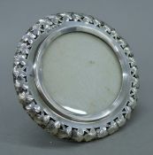 A florally-pierced silver picture frame. 13.5 cm diameter.